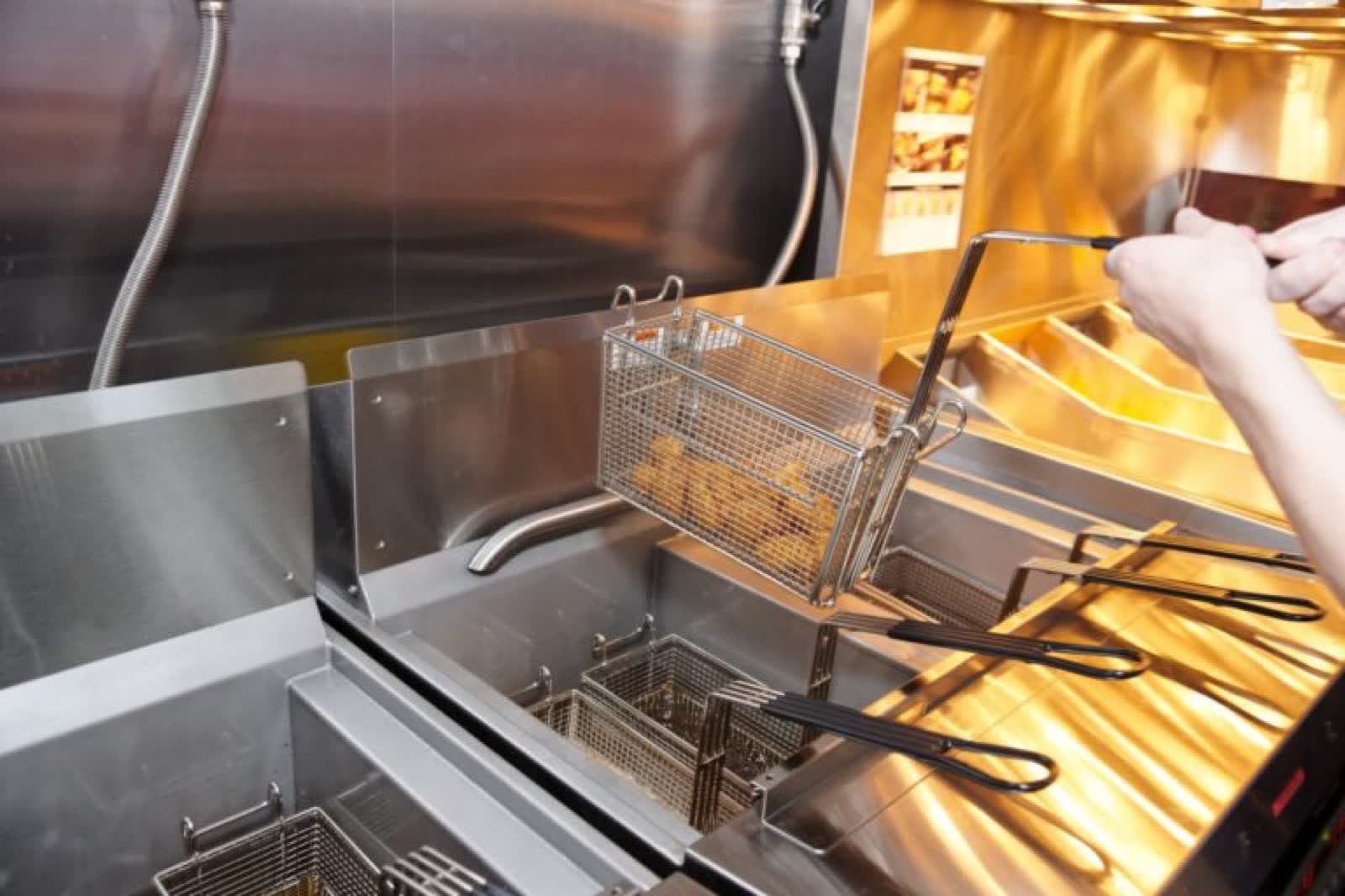 Commercial deep fryer being serviced
